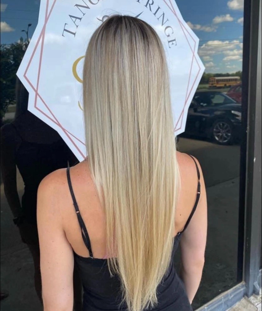 close up of long blonde hair that has been trimmed and styled
