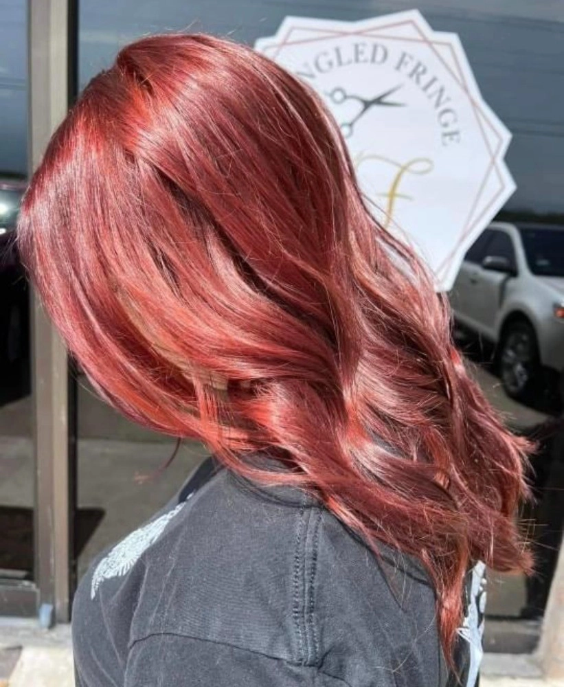 close up of hair dyed red and styled